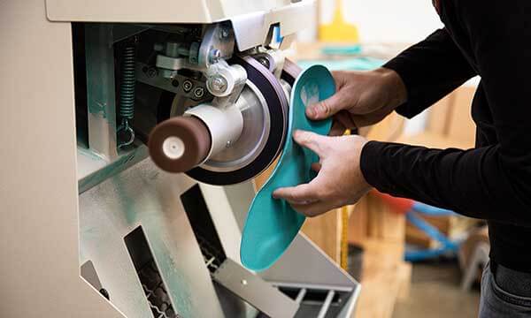 A pedics specialist working on a custom orthotic in the pedics lab.