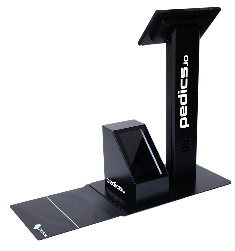 The pedics terminal in black in side view. It consists of a monitor stand with a touch screen, a 3D foot scanner and a pressure plate.